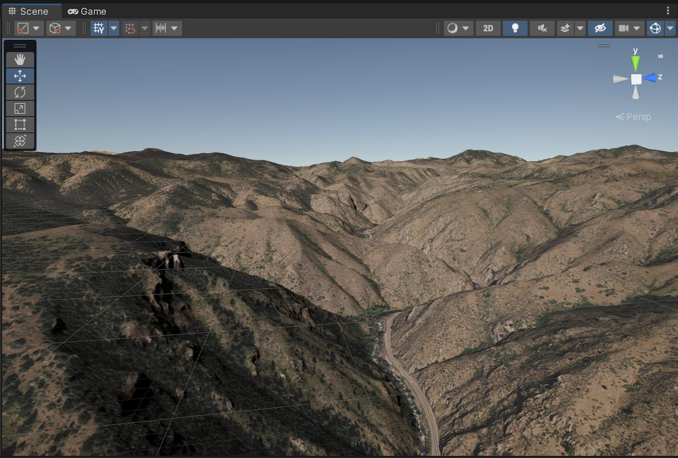 Terrain will start to appear in the scene. This scene shows brown and green foothills with a blue sky at the top and a road in the middle.