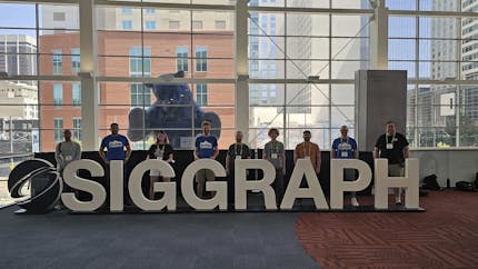 Cesium team members at SIGGRAPH 2024, in front of the iconic Blue Bear at the Colorado Convention Center.